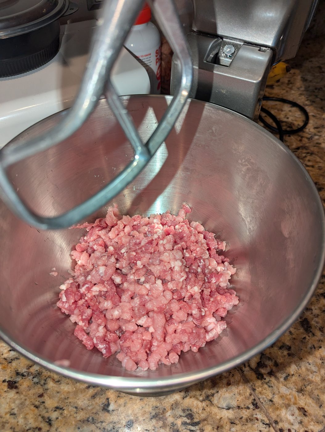 Freshly coarse-ground pork in the mixing bowl