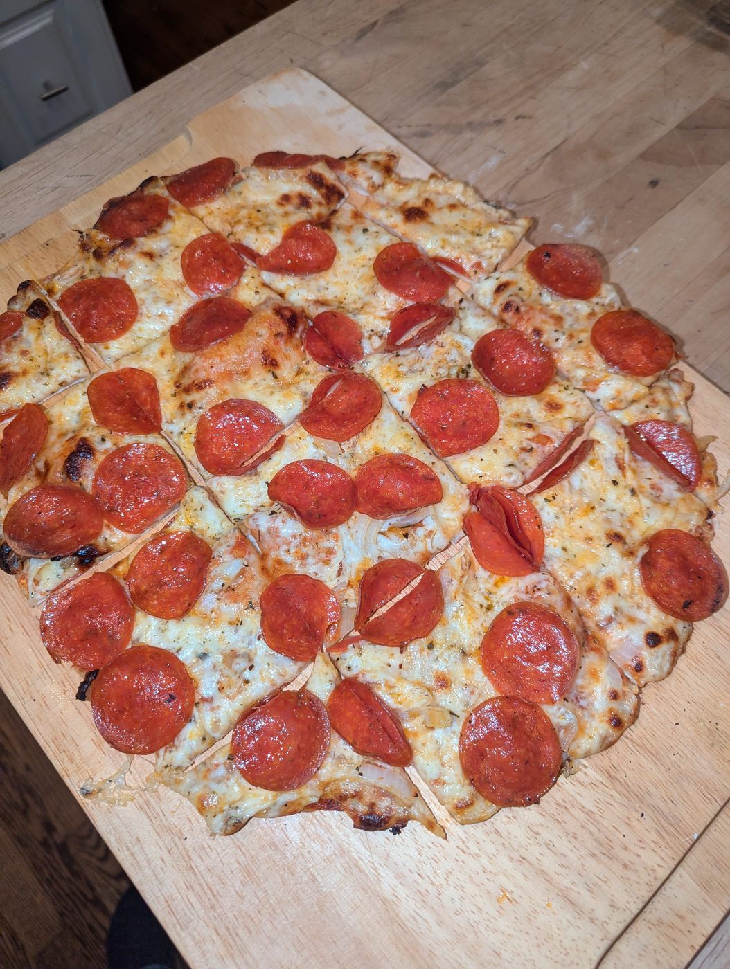 Rectangular pepperoni pizza with onions