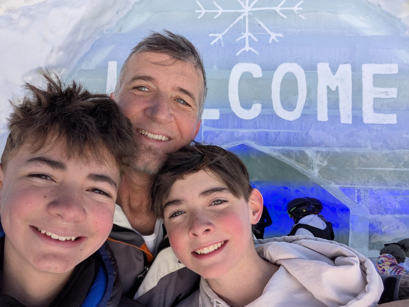 Father and sons in front of an ice sculpture